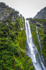 Waterfall in Milford Sound lake, New Zealand