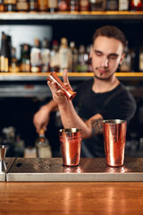 Cocktail. Bartender Making Cocktails in Bar