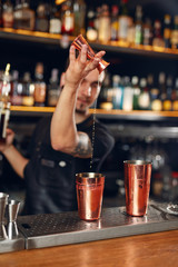 Cocktail. Bartender Making Cocktails in Bar
