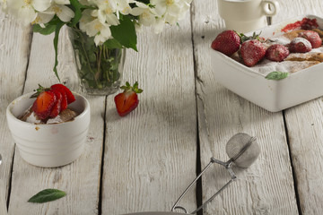 Cottage cheese casserole in white dish decorated with strawberries