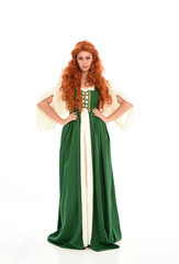 Obraz na płótnie Canvas full length portrait of red haired girl wearing long green medieval gown. standing pose, isolated on white studio background.