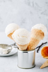 Homemade Vanilla Ice Cream scoop in waffle cones