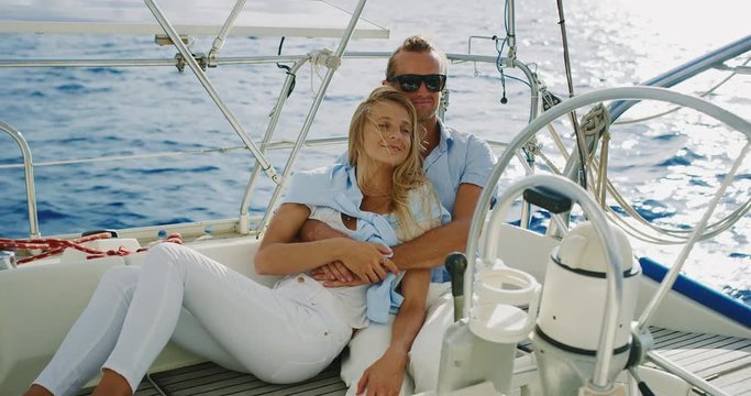 Attractive couple enjoying beautiful day sailing