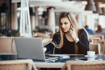 Young beautiful girl preparing for exams with laptop, surfing articles about innovations in web development, programming and design. Business lady working through internet in digital marketing field.