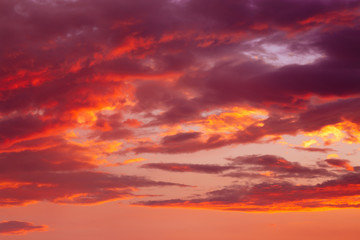 Dramatic cloudscape in a sunset. Pink and orange clouds in the warm sun.