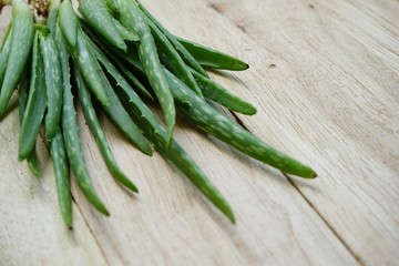 Aloe vera on wooden table background, copy space, skin care concept