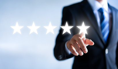 Businessman pointing five star to increase. Customer feedback and experience concept.