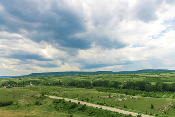 Fototapeta premium Road between green hills and