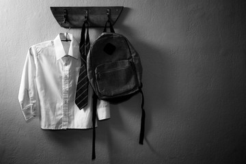 School uniform and schoolbag hanging on hook