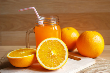 Orange and orange juice on wooden background