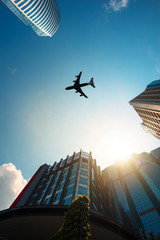 Fototapeta premium Airplane flight over the modern buildings of a big city