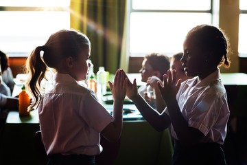 Girls playing clapping game