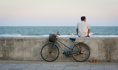 A man sitting and looking at the sea