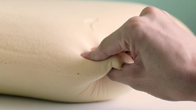 Mano che tocca un materasso in memory foam tecnologico. Super Slow motion.
