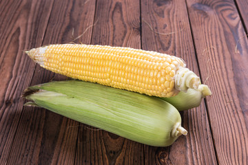 Fresh sweet corn on table