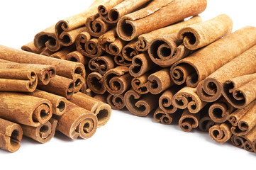 Pile of cinnamon in sticks isolated on white