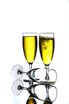 wine glasses full of yellow wine with bubbles