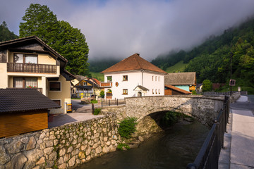 Fototapeta na wymiar Stone bridge in small mountain town Zelezniki in Carniola region, Slovenia .
