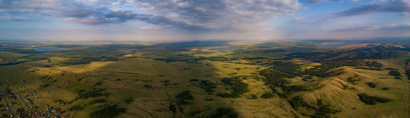 Fototapeta premium Panoramic view from drone of the fields near mountains