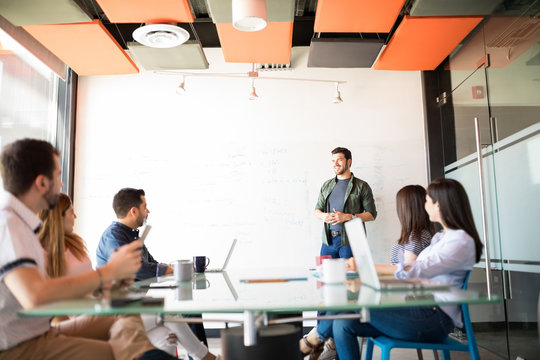 Businessman Giving A Sales Pitch To Team