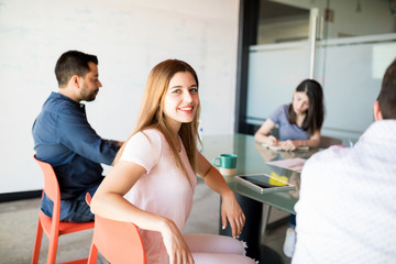 Friendly female executive amongst colleagues