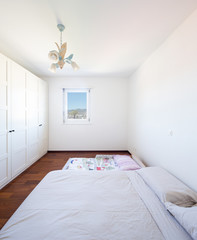 Bedroom with window and bed on the ground