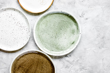 ceramic tableware top view on stone background mock up