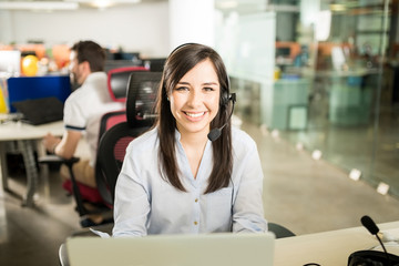 Woman with headset working in office