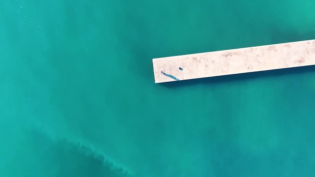 Aerial shot from above a jetty and amazing turquoise water