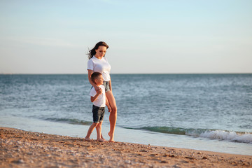 Young mother with son in white T-shirts