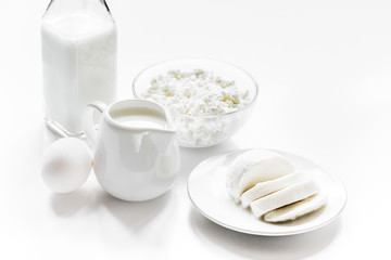 monochrome concept with dairy products on white table
