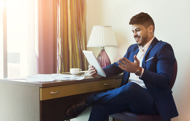 Businessman with digital tablet working at hotel room