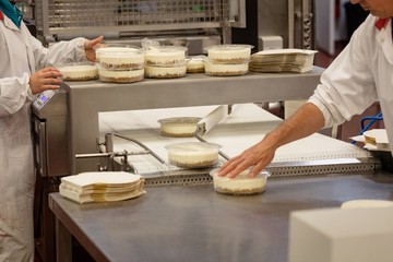 Mid section of workers packing foods
