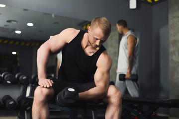 Fototapeta na wymiar Muscular bodybuilder doing heavy deadlifts at gym