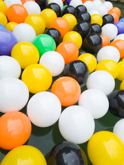 Large party balls, in diagonal view, with several luminous colors and reflections of the sky, create happy decoration outdoors.
