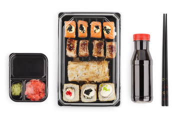 set of sushi rolls in a plastic box, delivered home ready to eat fast healthy food, isolated on white top view