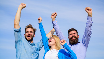 Employees enjoy feeling of freedom. Freedom concept. Company happy colleagues office workers enjoy freedom friday evening, sky background. Men with beard in formal wear and girl finished working week