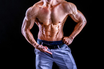 Fototapeta na wymiar Front view body of muscular biceps sportsman or bodybuilder isolate on black background