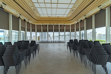 Conference Hall or Meeting Room  Modern Interior Panoramic windows with city view. Chairs and Stage for Business Presentation.