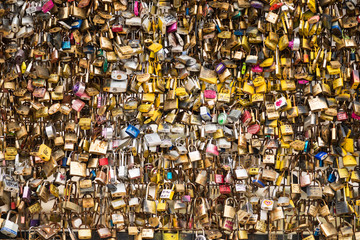 Love padlocks at Pont de l'Archeveche in Paris. The thousands of locks of loving couples symbolize love forever.