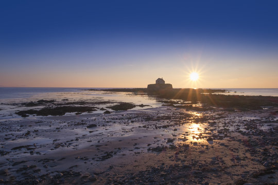 Cwyfan chapel on Anglesey, North wales, at sunset.