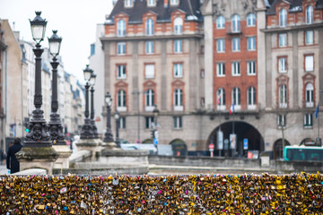 Fototapeta premium Love padlocks at Pont de l'Archeveche in Paris. The thousands of locks of loving couples symbolize love forever.