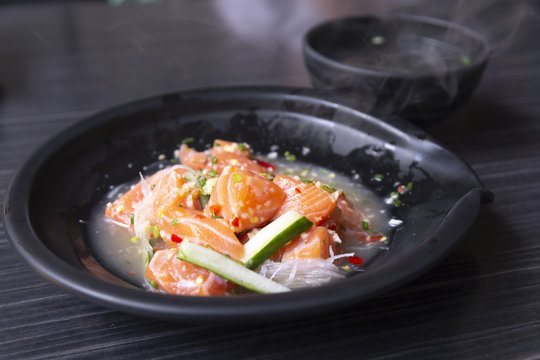 Japanese spicy salad sashimi salmon with Premium fresh raw seafood on wood background