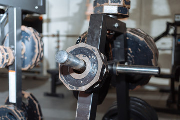 Disassembled barbell on floor in gym.Sports equipment. diverse equipment and machines at the gym room
