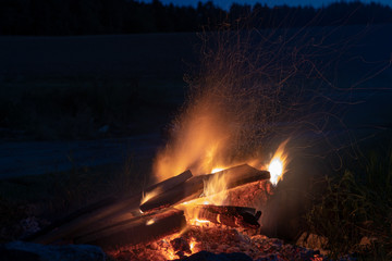 Marshmallows roasting over campfire in the evening