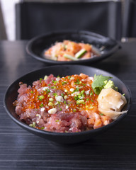 Premium fresh raw seafood mixed rice bowl (Kaisen-don/ Japanese tasty food), Japanese Rice with sashimi of tuna, Maguro, Otoro, salmon and ikura (Salmon eggs) on wood background
