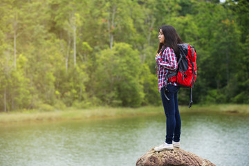 asian woman backpacker at lake side and mountain
