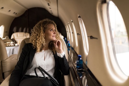 Businesswoman travelling in private jet 