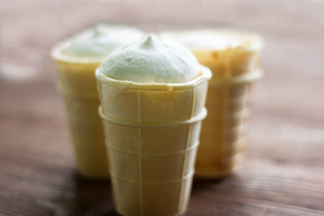 plain white vanilla ice cream in waffle Cup on wooden background