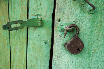old bolt and opened lock on wooden doors